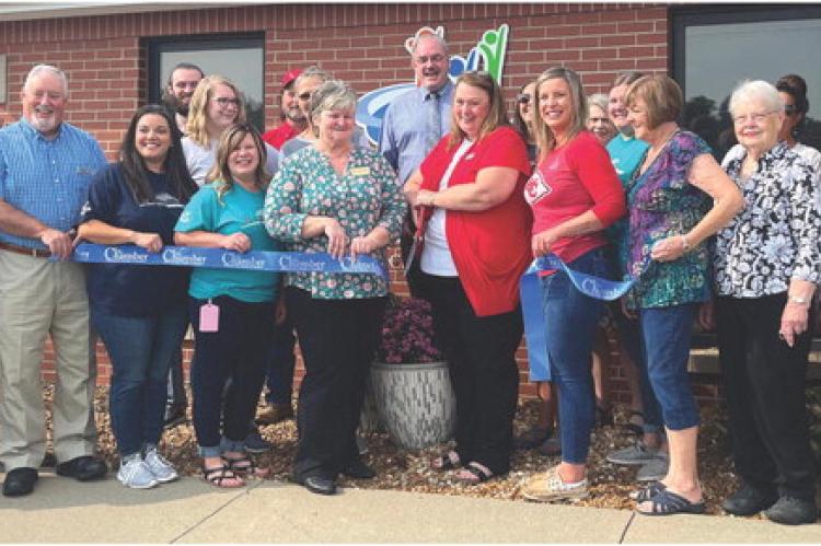 CMCCU branch manager Felicia Farabee, center, cuts the ribbon on the newly remodeled credit union facility during a Sept. 15 grand reopening event. SOPHIA BALES | Staff