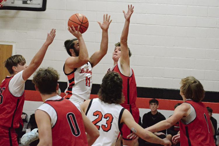 HARDIN-CENTRAL SENIOR Denver Douglas (No. 11) attempts a one-handed, first-half jump shot.
