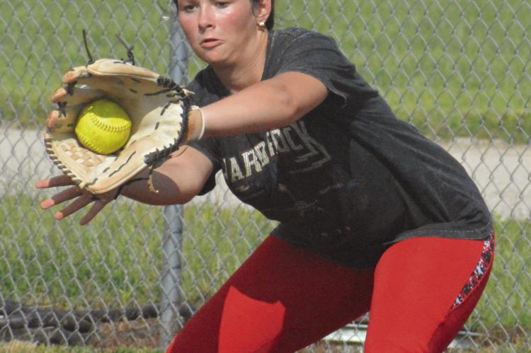 DANI DUNKIN snags a throw to first base during NHC softball practice Aug. 15 at Norborne.