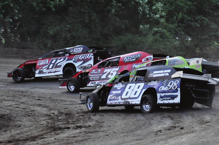 DRIVING THE NO. 82 car, Richmond’s David Wood makes sliding through a tight turn at Central Missouri Speedway near Warrensburg look way cool, as do a few stockcars behind him. SHAWN RONEY | Staff
