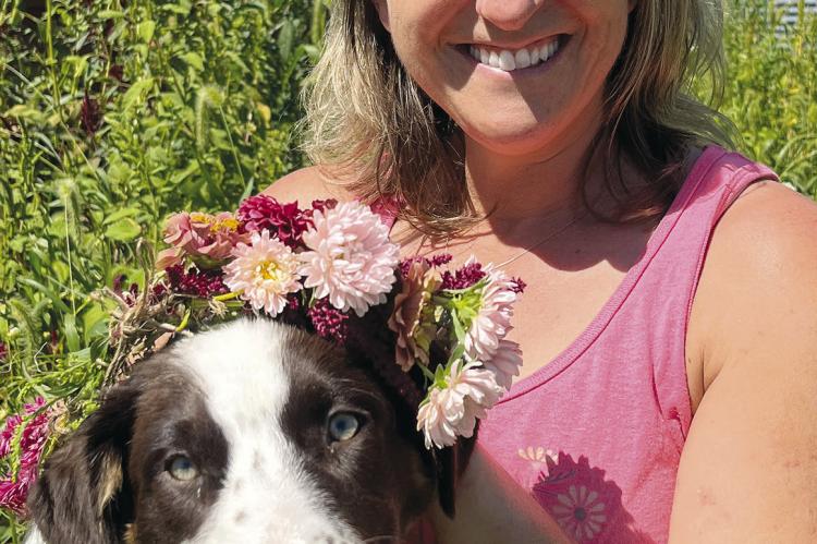 BETH FORTIN, owner of Little Green Garden LLC since 2017, got inspired by her own backyard. Fortin is shown here with her puppy, Delta. SOPHIA BALES | Staff