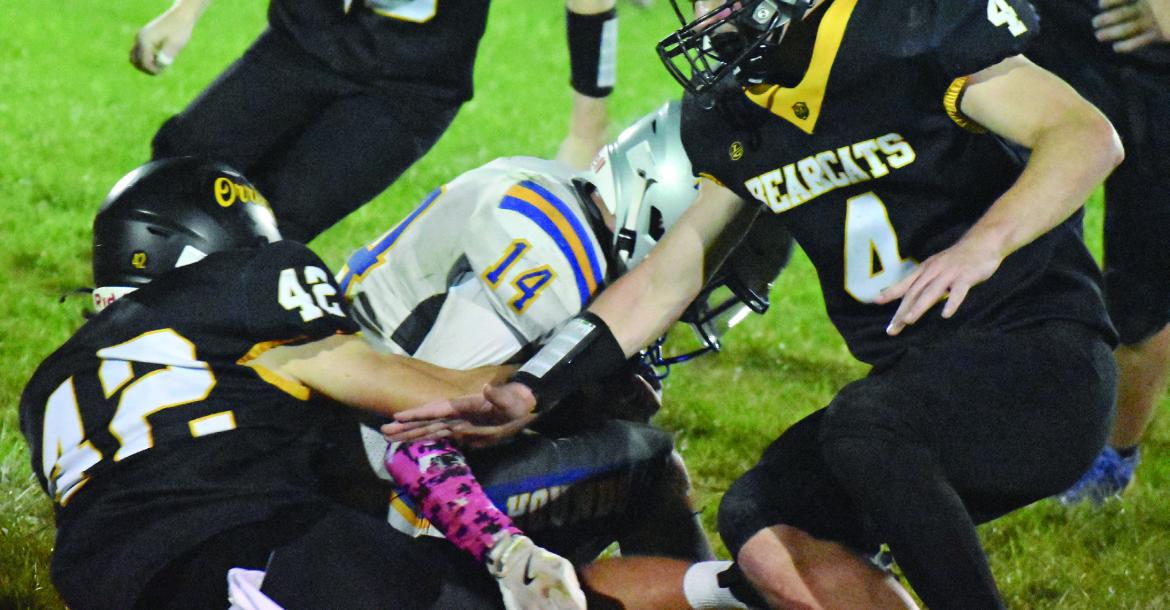 CARSON CLAYPOLE (left) makes a tackle as Levi Fielder rushes in to assist during Orrick’s homecoming game with Sweet Springs. SHAWN RONEY | Staff