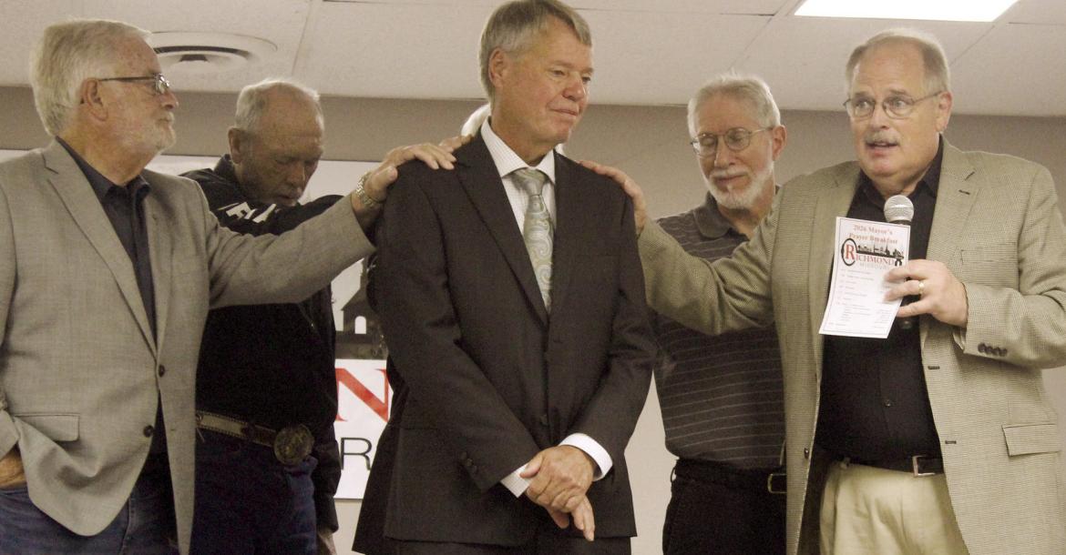 PASTORS BILL PURCELL (from left), Mike Stephens, Dave Donaldson and Willie Isaacson lay hands on Richmond Mayor Mike Wright (center) while offering a prayer for his leadership and guidance during the 2026 Mayor’s Prayer Breakfast. SHARON DONAT | Staff