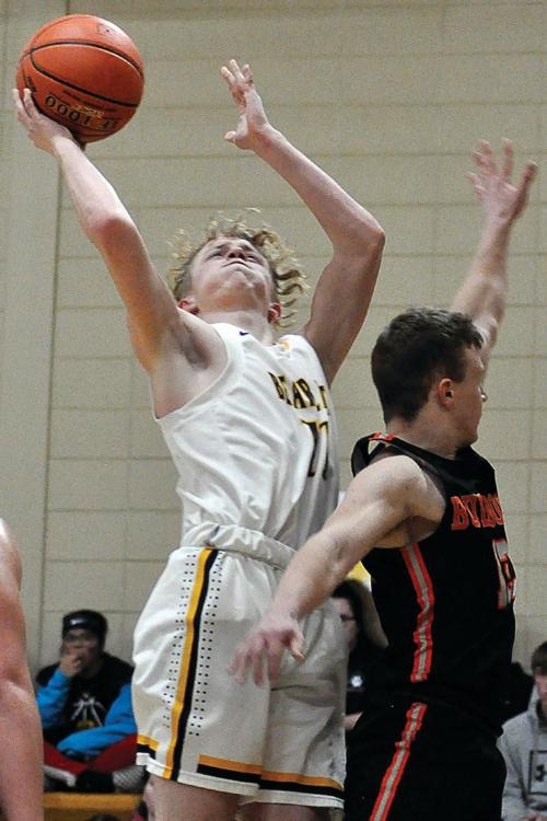 BLAKE BUCHANAN, No. 11, goes up to attempt a one-handed jumper Friday night during Orrick's 55-43 non-conference, courtwarming win over Hardin-Central.