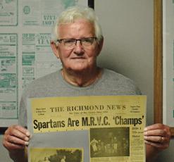 RICHMOND HIGH SCHOOL alumnus Norman Bowman displays a 1962 newspaper clipping about the Spartans’ conference title run in varsity football. SHAWN RONEY | Staff