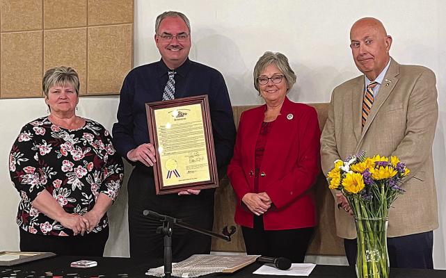 FROM LEFT: Renee Kellerman, Brian Rice, Peggy McGaugh and Terry Thompson face the crowd during the chamber’s 75th anniversary celebration as the two state representatives congratulate their accomplishments with a proclamation from the state. SOPHIA BALES | Staff
