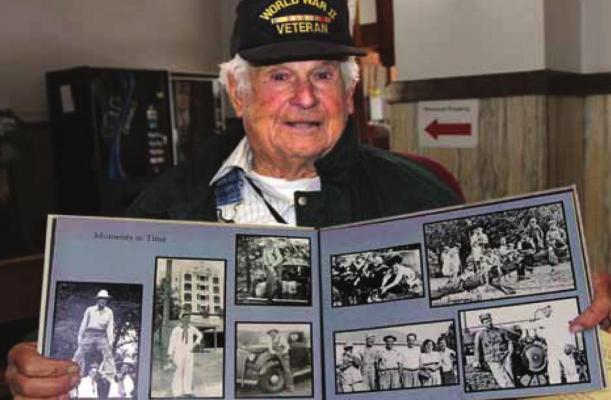 RAY COUNTY’S oldest World War II veteran, Ken Thomas, holds a scrapbook full of photos he collected during the war, when he worked to rework faulty torpedo firing pins in a Pearl Harbor machine shop. J.C. VENTIMIGLIA | Staff