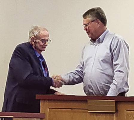 BOB BOND (left) receives a handshake from Mayor Mike Wright after retiring from Richmond City Council with 12 years of service. SHARON DONAT | Staff
