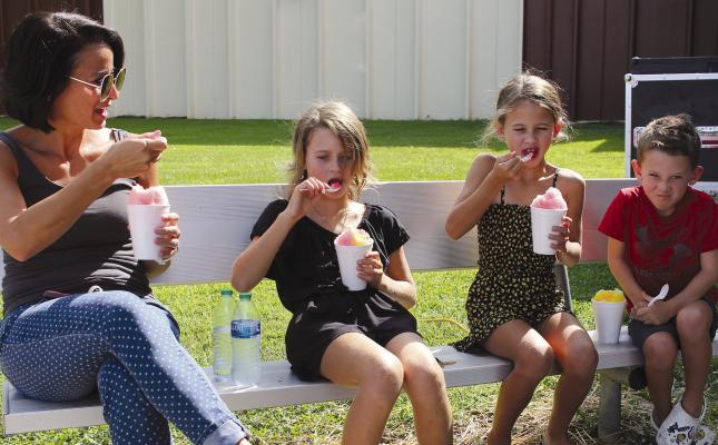 ANGELA, SUMMER, Minnie and Barrett Habermehl cool off with snow cones on the warm day. SOPHIA BALES | Staff