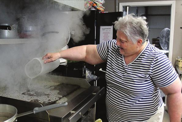 STEAM RISES as Director Pat Mills cleans the grill to prepare a fresh meal at the Ray County Senior Center. J.C. VENTIMIGLIA | Staff
