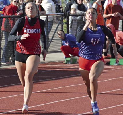 KAYLEE PUGH (left) fights off a challenge from LaNiya Davis in the girls 100-meter dash during the Bill Hamann Invitational April 11 at Lexington. SHAWN RONEY | Staff
