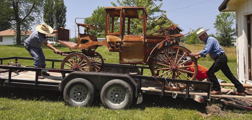 Bob Green (left) and Greg Quin hoist the Landau carriage onto a trailer for transport to its place for restoration. Once restored, the carriage will be returned to the Ray County Museum. SOPHIA BALES | Staff