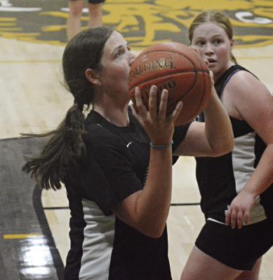 LIBBY FIFER takes aim near the bucket as she and her Hardin-Central teammates scrimmage against Orrick in varsity girls basketball July 13 in the Orrick High School gym. SHAWN RONEY | Staff