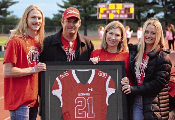 EVAN VANDIVER’S football jersey has been retired at Richmond High School. Family members displaying the jersey before Richmond’s Oct. 13 meeting with visiting Knob Noster are (from left) Ashton, Gary, Penny and Abby Vandiver. SHAWN RONEY | Staff