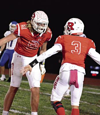 RICHMOND SENIOR lineman Jack Gogue, No. 51, seen celebrating in October 2022 with quarterback Donivin Williams, plans to continue his football career at New Mexico State University. SHAWN RONEY | Staff