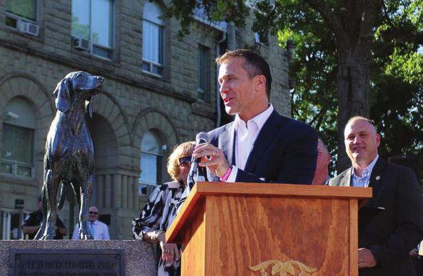 Staff THEN-GOV. Eric Greitens gives Sen. George Graham Vest’s “Eulogy to a Dog,” written in honor of Old Drum, during a bill-signing ceremony in June 2017 on the Warrensburg square in front of the dog’s statue. Behind Greitens stands Sen. Denny Hoskins, whose bill made Old Drum the official state historical dog.