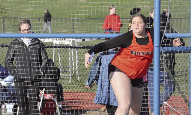 HANNAH FINLEY, a first-year high schooler at Hardin-Central, winds up to attempt a discus throw Tuesday during the Bulldogs’ season-opening meet at Lexington. SHAWN RONEY | Staff