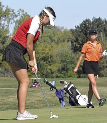 WITH A member of her group watching from behind, Richmond junior Kylie Holland attempts to putt Oct. 5 during Class 2 District 4 play at Lawson. SHAWN RONEY | Staff