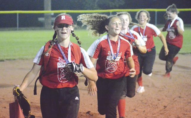 MEMBERS OF THE Richmond 1-Ellis Farms ballclub display their medals and run a victory lap around the bases after winning the Tri-County 13U Softball Tournament Tuesday night at Southview Park. SHAWN RONEY | Staff