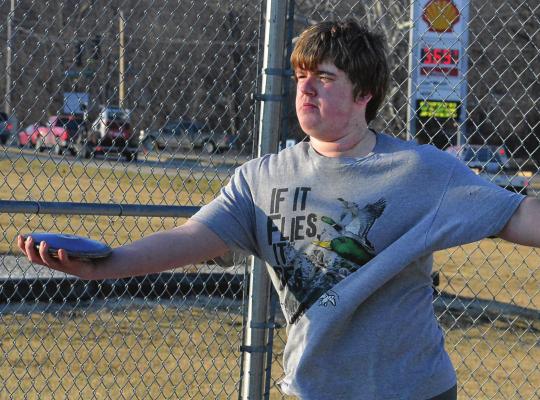 AT THE press’ request, Richmond sophomore Jake Cringan attempts a discus throw late in the afternoon March 3 on the high school campus. SHAWN RONEY | Staff