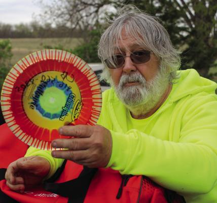 KNOXVILLE RESIDENT CHARLIE BAKER shows a disc used for disc golfing — a sport he enjoys in groups and alone. Baker is looking forward to making his hobbies into shared experiences with other disc golfers. SOPHIA BALES | Staff