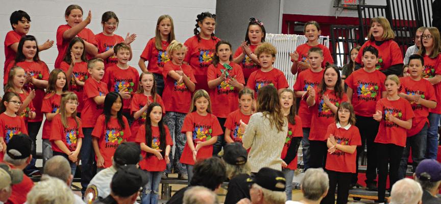 MEMBERS OF the Sunrise Singers, a vocal ensemble based at Sunrise Elementary School, work in some hand gestures as they perform for area veterans and their fellow Richmond students in the high school gym. SHAWN RONEY | Staff