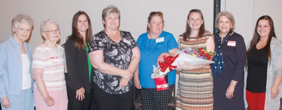 COURTNEY COLE accepts gifts from Renee Kellerman during the Richmond Area Chamber of Commerce Luncheon. Representing their businesses are June Harrison (from left), Donna Matthews, Katherine Boruch, Kellerman, Jayne Taylor, Cole, Stephanie Landwehr and Lauren O’Dell.