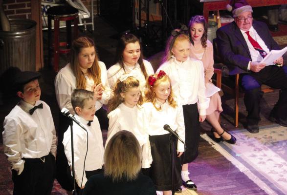 MISS OPAL’S 42nd Street Kids Choir sing in “A Christmas Carol, A Live Radio Play”, written Joe Landry. Shown in no particular order, are Abigail Garland, Anna Garland, Addison Garland, Ryker Kugler, Isabella Hendley, Paige Quick and Max Wrisinger