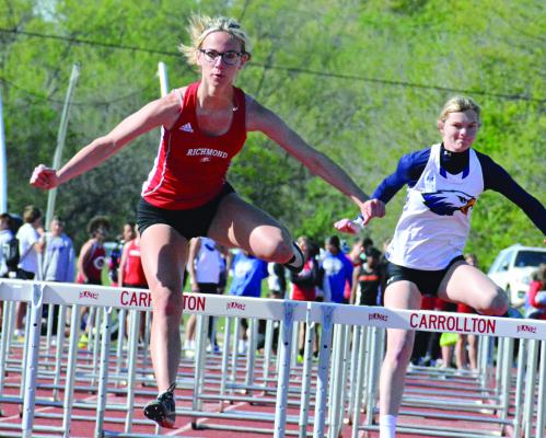 RICHMOND SOPHOMORE Kaylee King goes airborne near the end of the 110-meter high hurdles Monday afternoon at the Missouri River Valley Conference East Division varsity girls meet at Carrollton. SHAWN RONEY | Staff