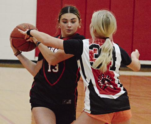 EMMA HASH (No. 13) shields the ball from Ella Steele during a Richmond girls basketball practice Nov. 6 at Sunrise Middle School.