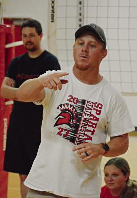 CODY HOGAN, who has added another coaching position to his responsibilities, talks to his Spartans during their end-of-summer team volleyball camp at Richmond High School. SHAWN RONEY | Staff