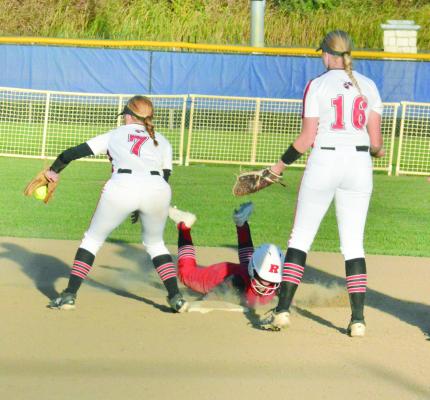 RICHMOND JUNIOR Sydney Appleberry dives safely back into second base between Chillicothe’s Kirsten Dunn, No.7; and Bre Pithan, No. 16, and to avoid getting caught in a rundown Oct. 13 in district play Oct. 13 at St. Joseph. SHAWN RONEY | Staff