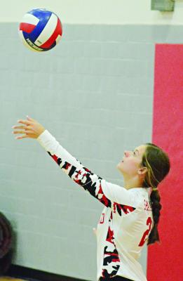RICHMOND SENIOR Grace Bozarth keeps her eyes on the volleyball as she tosses it up to serve against Brookfield Sept. 30 in tournament play at Carrollton. SHAWN RONEY | Staff