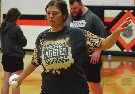 USING A bowling pin, Hardin-Central senior Abby McNelly works on her discus technique March 7 in the Hardin-Central gym. SHAWN RONEY | Staff