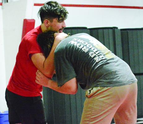 EVAN BATES (left) works on his wrestling holds during a Nov. 8 practice in the multipurpose building on the Richmond High School campus.