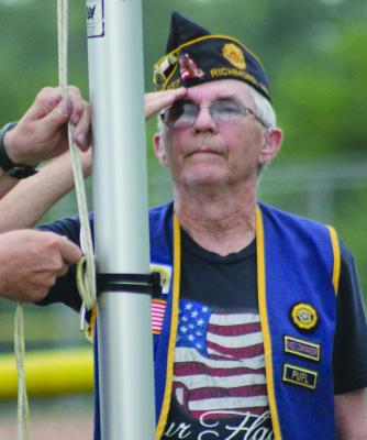 American Legion Outgoing Commander Jim Richardson salutes as American Legion Incoming Commander Jack Lauck raises the flag. The duo participated in Richmond’s Annual American Celebration. SOPHIA BALES | Staff