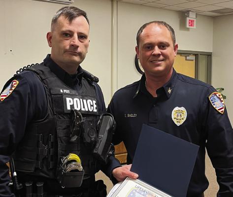 RICHMOND POLICE Department Patrol Officer Brandon Peet (left) receives a “Life-Saving Commendation” from Chief Scott Bagely. SOPHIA BALES | Staff