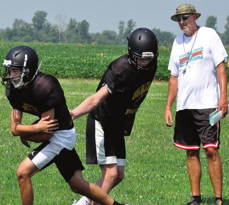 ORRICK VARSITY coach and Richmond High School alumnus Kirk Thacker watches his Bearcats work on running his “regular offense” during a team camp session Monday on the school’s practice field. The Bearcats are slated to participate in a multiteam camp Friday at Albany. SHAWN RONEY | Staff