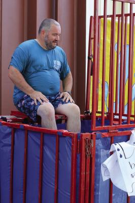 BRANDON QUICK, Richmond high school principal, lets participants dunk him during the Richmond Back to School Bash Tuesday. The dunk tank is a fundraiser for the junior class.
