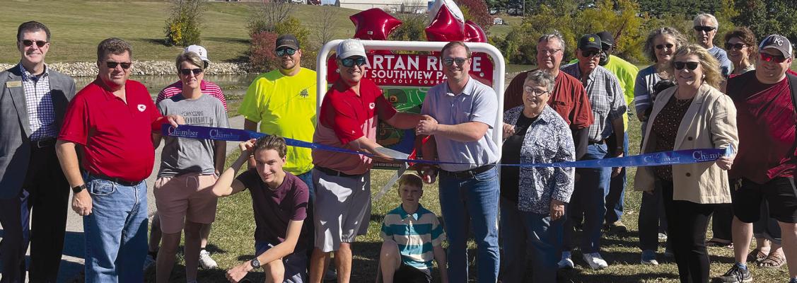 RICHMOND RESIDENT Dr. Ryan Lauck (center, left) and former Richmond City staffer James Gorham (center, right) cut the ribbon to celebrate the city’s Spartan Ridge at Southview Park disc golf course opening. Community leaders and members showed support for the event. The ribbon was provided by the Richmond Area Chamber of Commerce. SOPHIA BALES | Staff