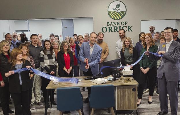 BANK OF ORRICK CEO/President Chris Bomheimer (middle) cuts ribbon during the reopening ceremony surrounded by the community and Richmond Area Chamber of Commerce members. SHARON DONAT | Staff