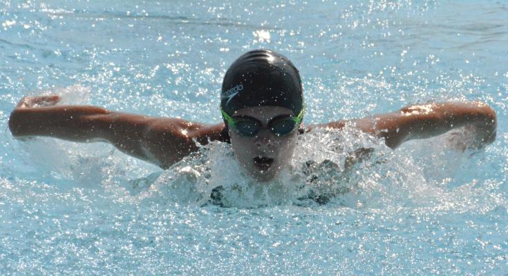 SHAWN RONEY | Staff GRACE BOZARTH displays her butterfly stroke skills while racing for the Dolphin Swim Team in conference competition July 22 at Southview Pool.