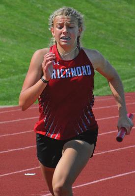 A FEW HOURS after helping to set the school record in the girls 800-meter relay, Kaylee Pugh runs in the 1,600 relay in district competition. SHAWN RONEY | Staff