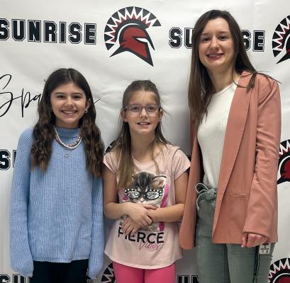 Submitted SUNRISE ELEMENTARY STUDENTS Baylee Crispen and Harper Hockemeier were excited to participate in the All-State Children’s Choir. Shown with the girls is music teacher Ms. Kaelyn Rich.