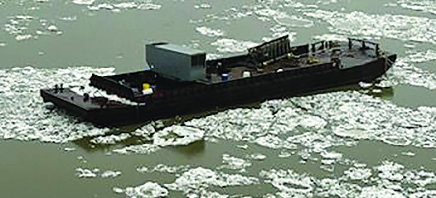 ONE OF TWO RUNAWAY barges float down Missouri River among ice flows. Submitted