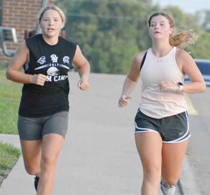 LIVIA CAVANAH, left, and Isabelle Dooley train for the Richmond High School cross country season – and to stay fit for cheerleading. SHAWN RONEY | Staff