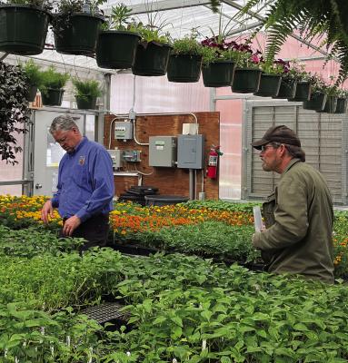 RHS TEACHER CHARLES FOREMAN (left) helps local resident Guy Kinnison pick some plants and vegetables during the RHS spring greenhouse sale. SOPHIA BALES | Staff