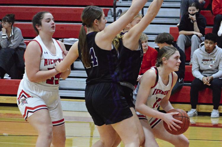 WITH RICHMOND TEAMMATE Paige Logsdon and two Bishop LeBlond of St. Joseph defenders behind her, sophomore Candiace Claypole looks to shoot in the post during Winter Classic action Monday night at Richmond High School. SHAWN RONEY | Staff