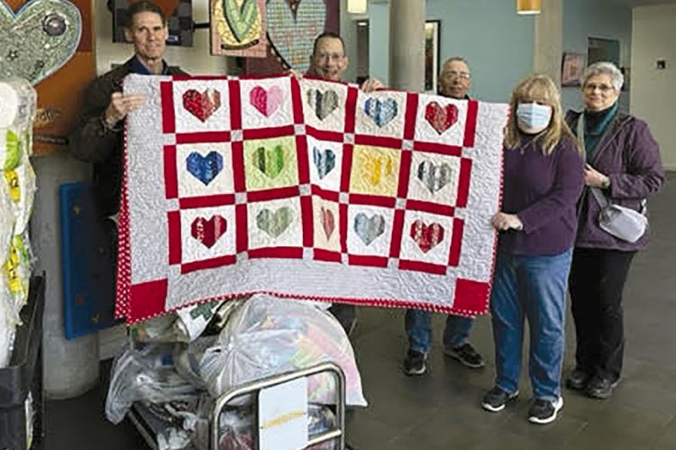 RAY COUNTY FARM BUREAU recently donated quilts handmade by Dona Profitt and Stephanie Wheeler. Shown, from left, are Ed Holbner, Alan Lubbert, Jim Proffitt, Wheeler and Dona Profitt. Each year, the bureau assists in purchasing food and supplies for the Ronald McDonald House, along with a monetary donation. MU | Submitted
