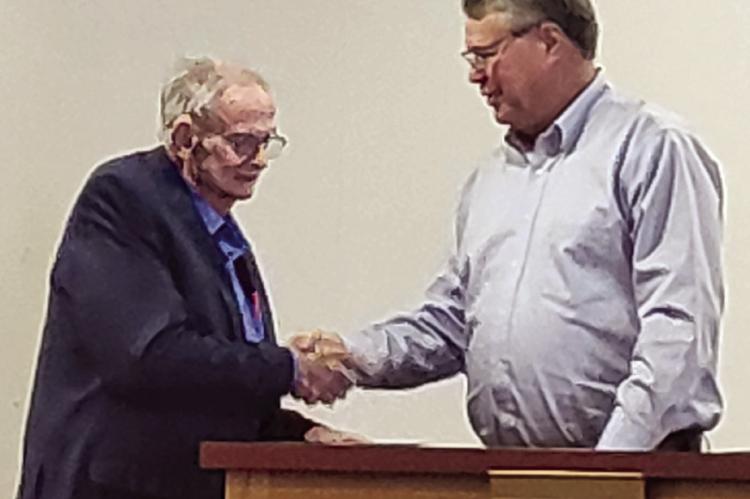 BOB BOND (left) receives a handshake from Mayor Mike Wright after retiring from Richmond City Council with 12 years of service. SHARON DONAT | Staff